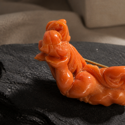 The Carved Coral Putto Brooch.