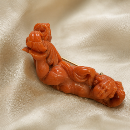 The Carved Coral Putto Brooch.