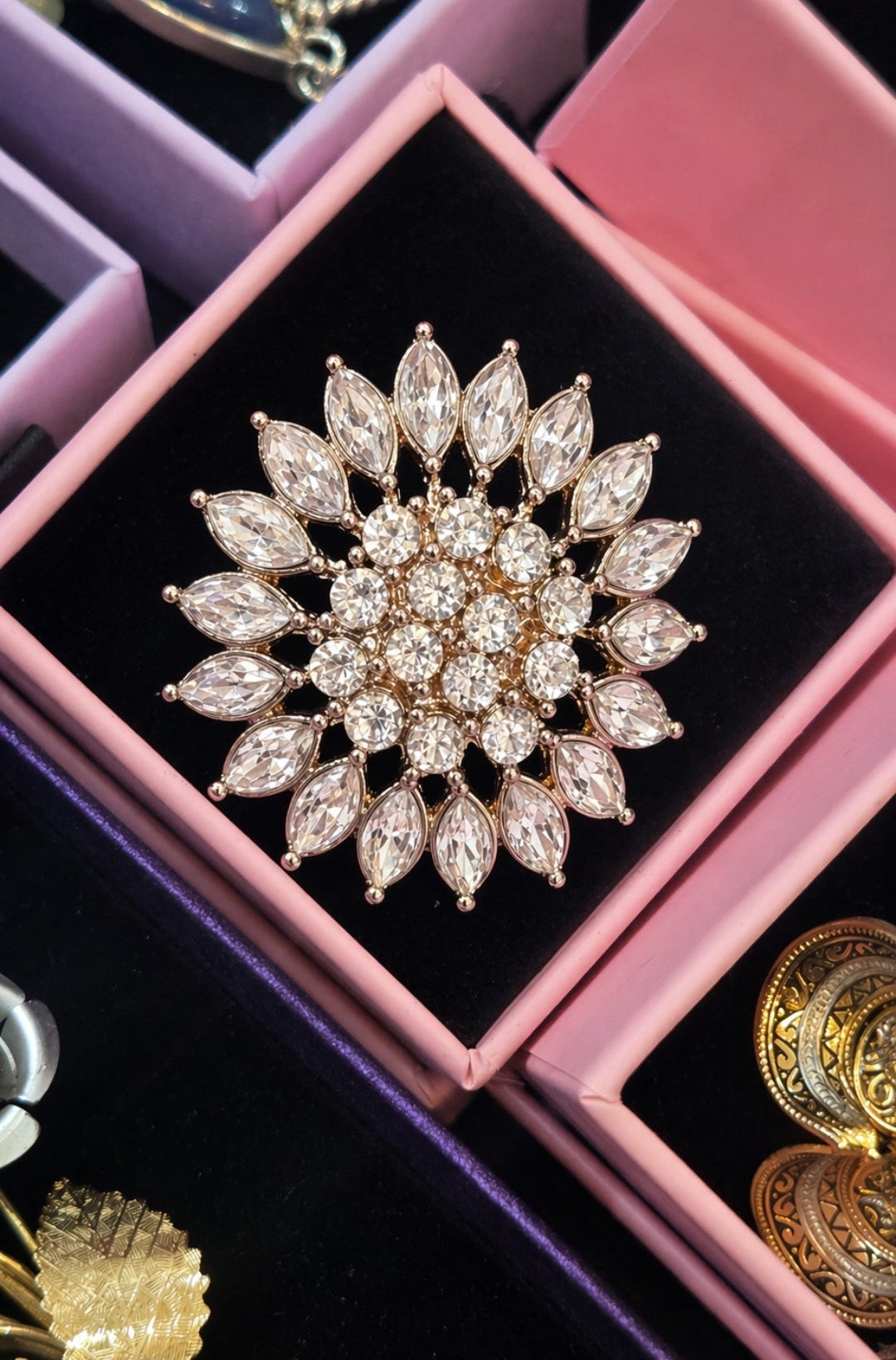 The Crystal Sunburst Brooch.